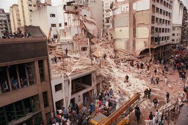 Aftermath of the AMIA bombing in Buenos Aires showing destroyed building facade and rubble